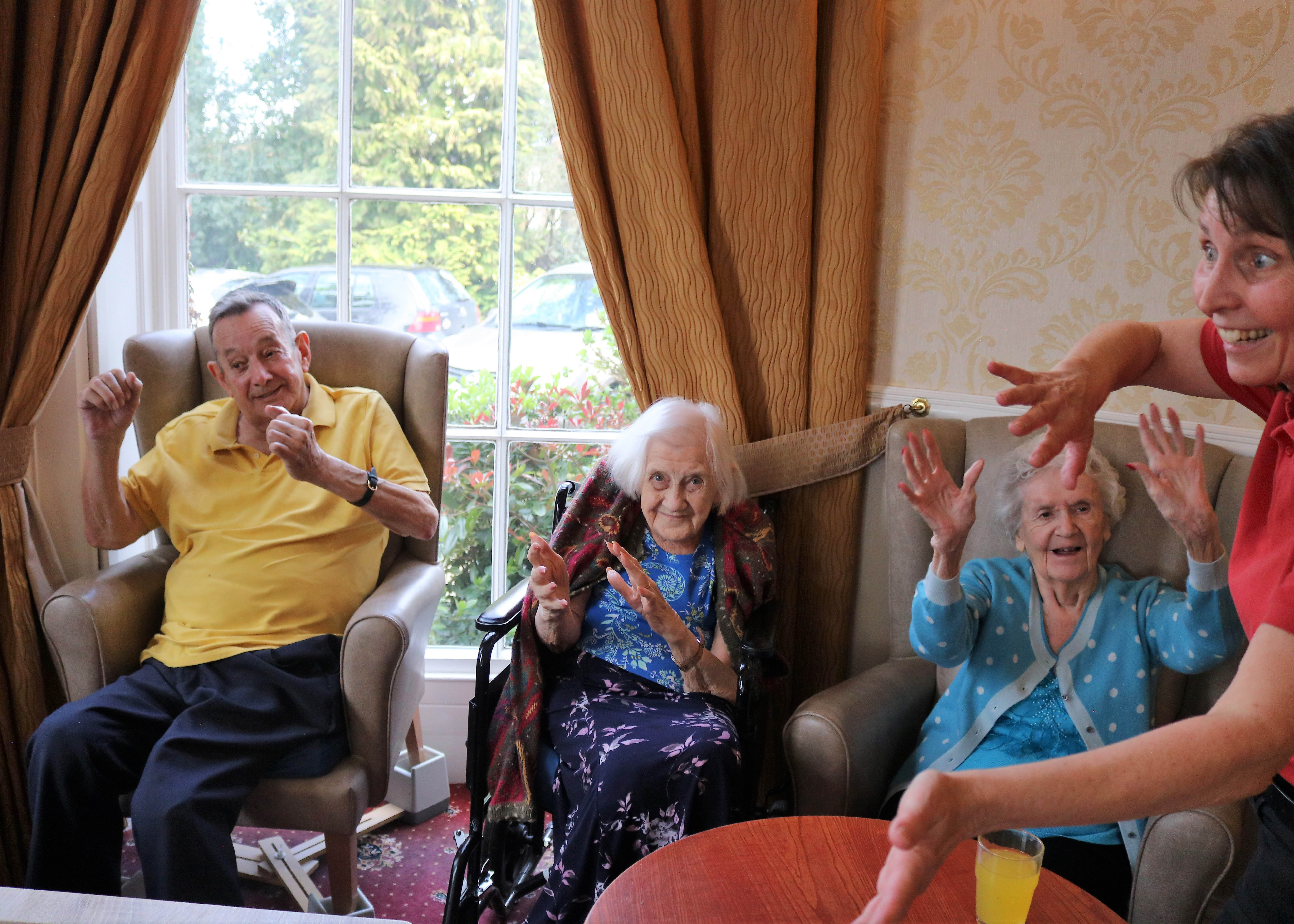 Residents dancing to the live entertainment with Wellbeing Coordinator Jeanette